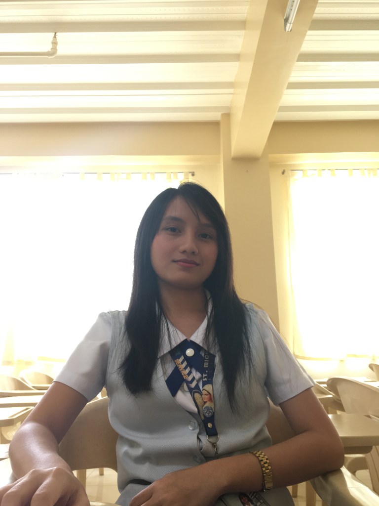 A person standing in front of a window

Description automatically generated