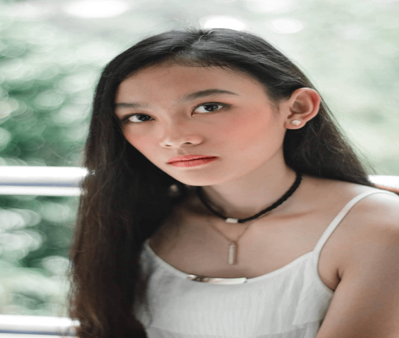 A person standing in front of a window

Description automatically generated